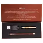 contents of cream vape kit box with vape pen, cartridge and charger